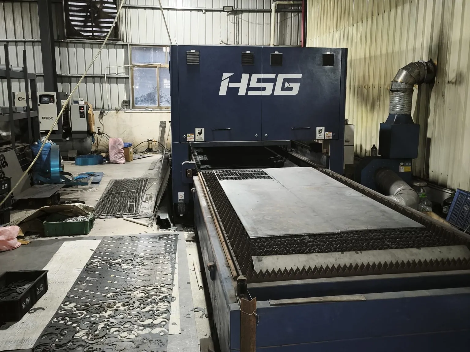 HSG laser cutting machine with a steel sheet on the cutting bed
