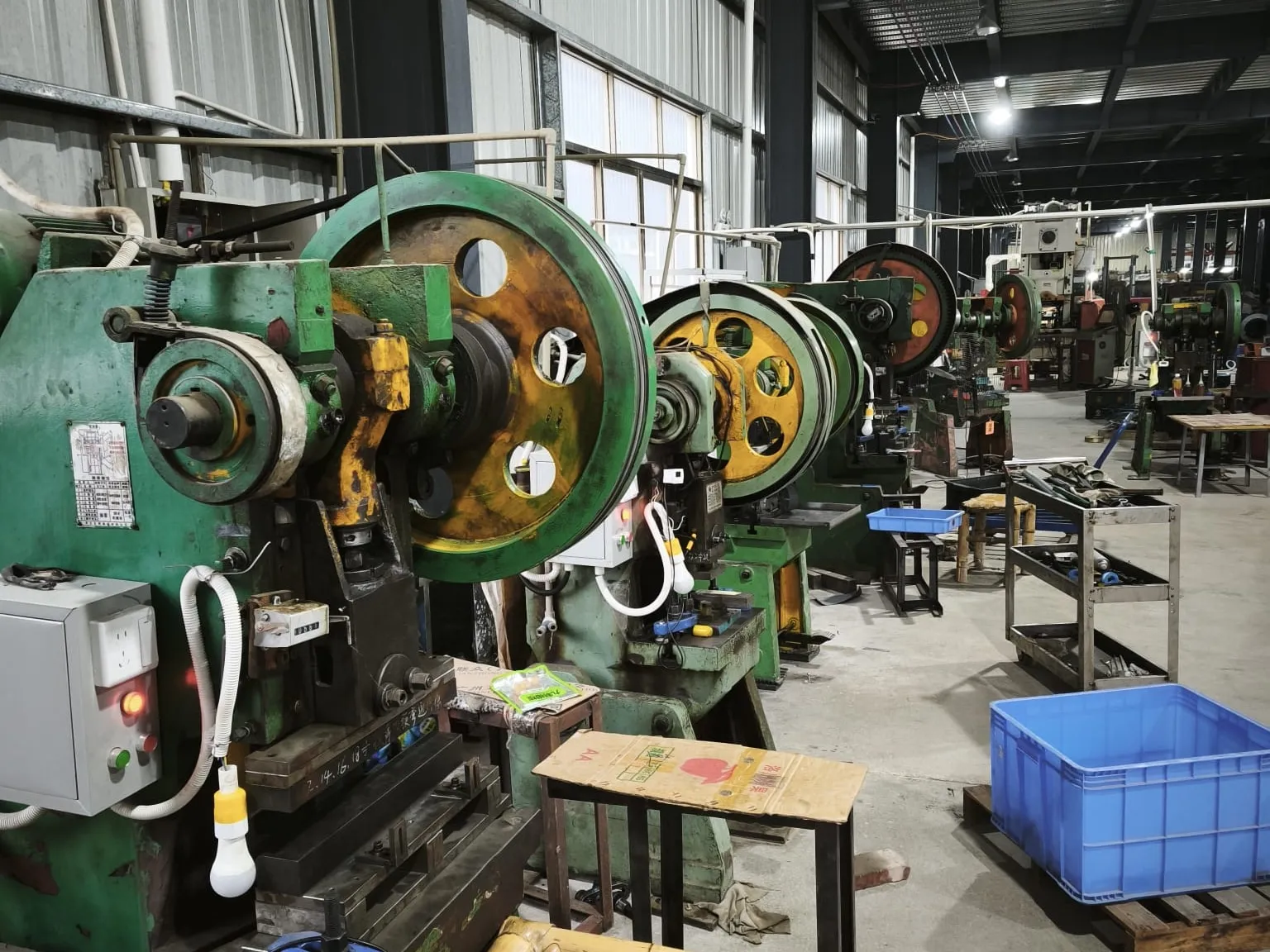 Row of open-back mechanical presses in the pressing bay